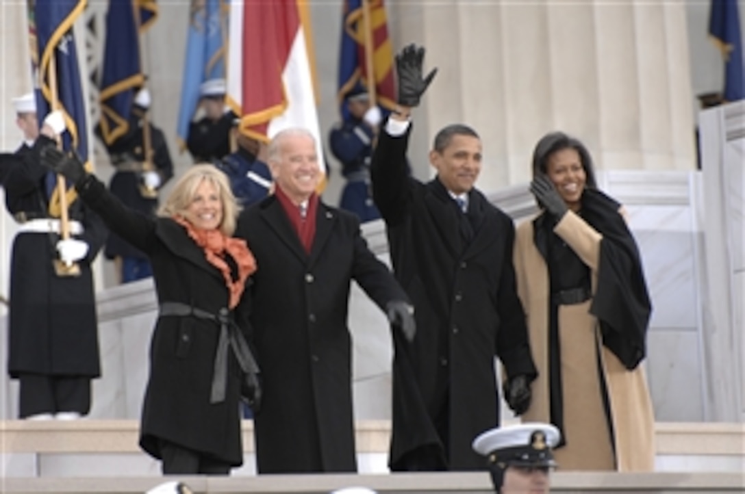 From Left: Jill Biden, Vice President-elect Joe Biden, President-elect Barack Obama, and Michelle Obama wave to the crowd during inaugural opening ceremonies at the Lincoln Memorial on the National Mall in Washington, D.C., Jan. 18, 2009. More than 5,000 men and women in uniform are providing military ceremonial support to the presidential inauguration, a tradition dating back to George Washington's 1789 inauguration.