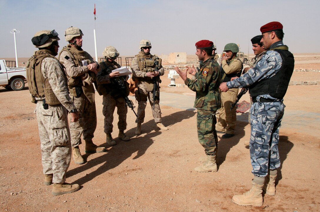 Marines from Company E, 2nd Battalion, 25th Marines speak with troops from the Iraqi Department of Border Enforcement at a remote fort near Iraq’s western border with Jordan Jan. 19, 2009.