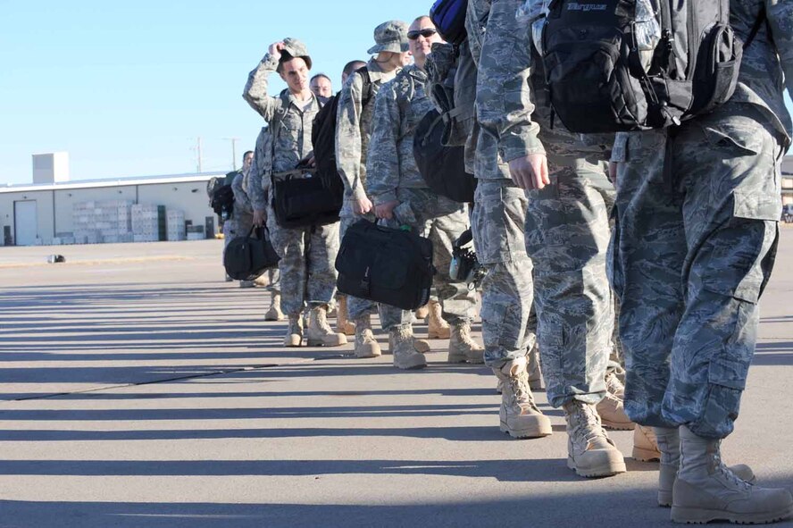 DYESS AIR FORCE BASE, Texas -- Members of the 7th Bomb Wing board a civilian contracted flight for deployment here, Jan. 20.  Approximately 300 of Dyess' Airmen will deploy in the next few weeks. (U.S. Air Force photo by Senior Airman Domonique Simmons)