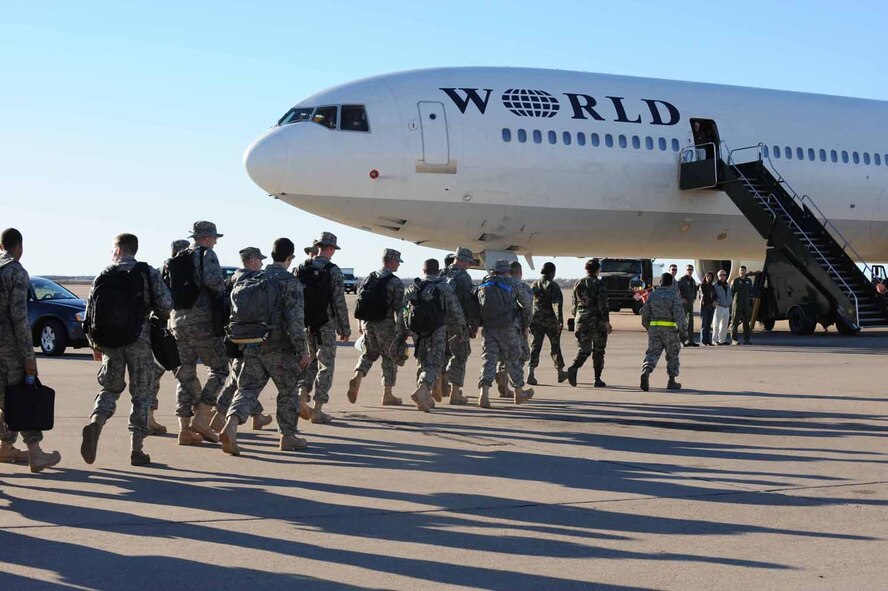 DYESS AIR FORCE BASE, Texas -- Members of the 7th Bomb Wing board a civilian contracted flight for deployment here, Jan. 20.  Approximately 300 of Dyess' Airmen will deploy in the next few weeks. (U.S. Air Force photo by Senior Airman Domonique Simmons)