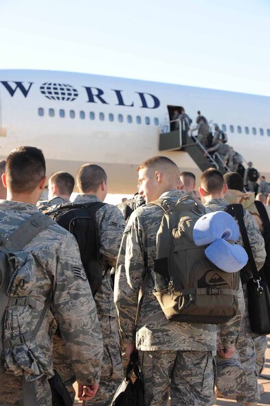 DYESS AIR FORCE BASE, Texas -- Members of the 7th Bomb Wing board a civilian contracted flight for deployment here, Jan. 20.  Approximately 300 of Dyess' Airmen will deploy in the next few weeks. (U.S. Air Force photo by Senior Airman Domonique Simmons)