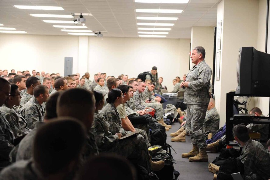 DYESS AIR FORCE BASE, Texas -- Colonel James Milburn, 7th Maintenance Group commander, enlightens Airmen with a speech about deploying here, Jan. 20. After processing through the personnel deployment function line, Airmen gather to board an aircraft that will take them to their deployed location. (U.S. Air Force photo by Senior Airman Domonique Simmons)
