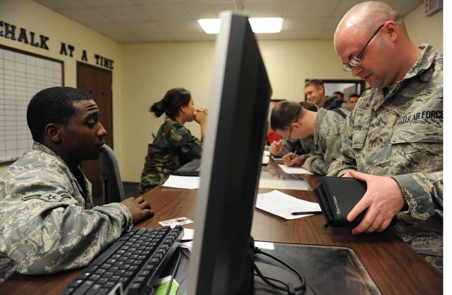 DYESS AIR FORCE BASE, Texas -- Technical Sgt. Robby Kerrison, from the 7th Aircraft Maintenance Squadron, signs in with the 7th Logistics Readiness Squadron at the personnel deployment function (PDF) here, Jan. 20. Deploying members from the 7th Aircraft Maintenance Squadron must report the combined weight of their carry-on bags and body weight when passing through the PDF line. (U.S. Air Force photo by Senior Airman Domonique Simmons)