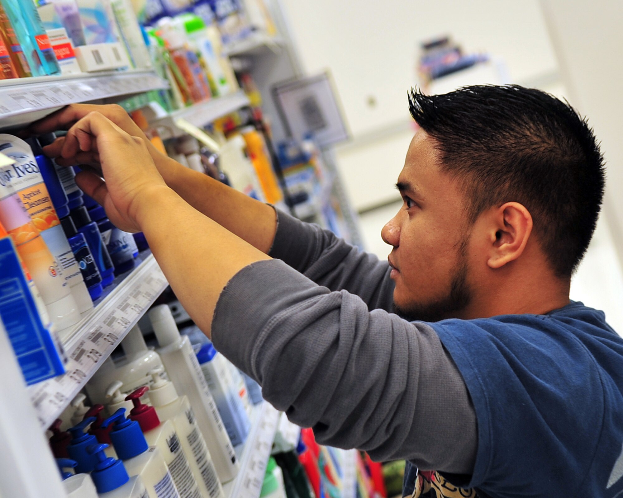 Army Air Force Exchange Services laborer Terrence Martin, husband of Airman 1st Class Lauren Martin, 354th Force Support Squadron, stocks shelves at the new base exchange. The new BX will house more merchandise and boast a larger food court. The grand opening is scheduled for Feb. 20 at 10 a.m.; the facility will have new hours, 10 a.m. to 8 p.m. seven days a week.  (U.S. Air Force photo by/Airman 1st Class Willard Grande)
