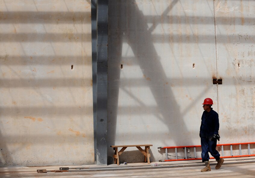 Senior Airman Andre Cervantes surveys construction on a tilt-style building Jan. 13 at Northwest field, Andersen Air Force Base, Guam. Once complete the site will be PACAF's future, premier Expeditionary Combat Skills Training Campus. The state-of-the-art training site will be instrumental in the continuing effort in supporting the Global War on Terrorism. Airman Cervantes is assigned to the 554th Red Horse Squadron at Andersen. 
(U.S. Air Force photo/ Master Sgt. Kevin J. Gruenwald) released

