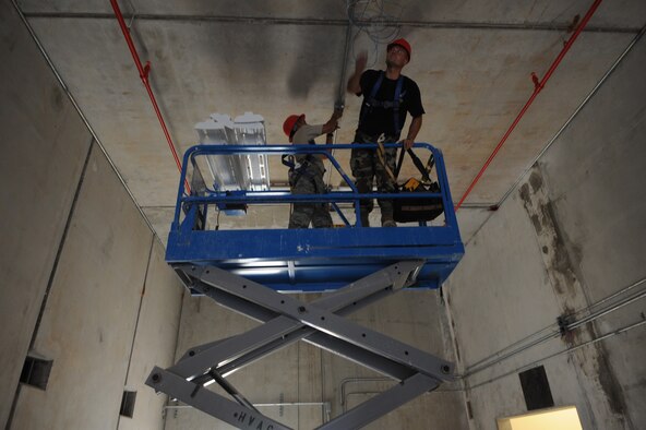 Airmen from the 554th Red Horse Squadron hang lighting fixtures Jan.13 at Northwest field, Andersen Air Force Base, Guam. The 554th and 254th have revived Guam's historical Northwest Field building PACAF's future, premier Expeditionary Combat Skills Training Campus. Once complete, the state-of-the-art training site will be instrumental in our continuing effort in supporting the Global War on Terrorism. The 10-year construction plan will provide 80 facilities and infrastructure supporting four units: 554th and 254th RED HORSE Squadrons, Commando Warrior, 644th Combat Communications and 554th Silver Flag.
(U.S. Air Force photo/ Master Sgt. Kevin J. Gruenwald) released
