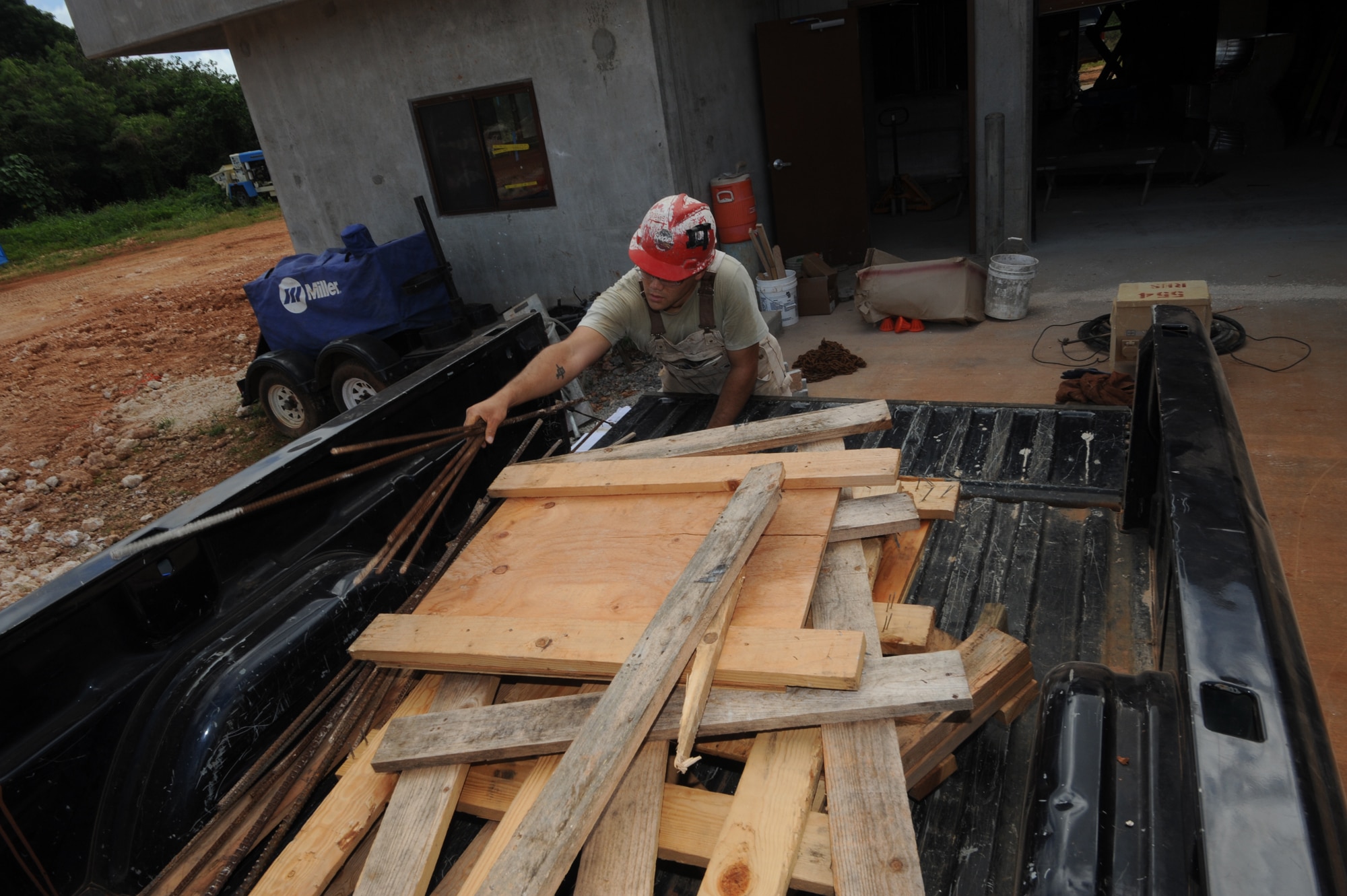Staff Sgt. Thomas Agee loads construction materials Jan.13 at Northwest field, Andersen Air Force Base, Guam. The construction plan will provide 80 facilities and infrastructure supporting four units. Northwest Field is going to become the home of Pacific Air Force’s premier Regional Training Center known as “Commando Warrior” as well as the 644 Combat Communications Squadron and the 554 RED HORSE Squadron and their “Silver Flag” training detachment.  Collocating the different units will enable each unit to benefit from the synergies it creates; becoming the first training center of its kind in the Pacific.  The mission of this Regional Training Center (RTC) is to enhance the combat readiness of Pacific Air Force forces through training and evaluation of Force Protection and Ground Combat Skills (GCS).  Sgt. Agee is assigned to the 554th Red Horse at Andersen.
(U.S. Air Force photo/ Master Sgt. Kevin J. Gruenwald)  