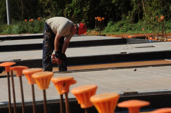Staff. Sgt. Brandon Hall prepares a wall mold for a tilt-up style building Jan. 13 at Northwest Field on Andersen Air Force Base, Guam. The 10-year construction plan will provide 80 facilities and infrastructure supporting four units: 554th and 254th RED HORSE Squadrons, Commando Warrior, 644th Combat Communications and 554th Silver Flag onto one base. Once complete, the state-of-the-art training site will be instrumental in the continuing effort in supporting the Global War on Terrorism. Sgt. Hall is assigned to the 554th Red Horse Squadron at Andersen.
(U.S. Air Force photo/ Master Sgt. Kevin J. Gruenwald) 