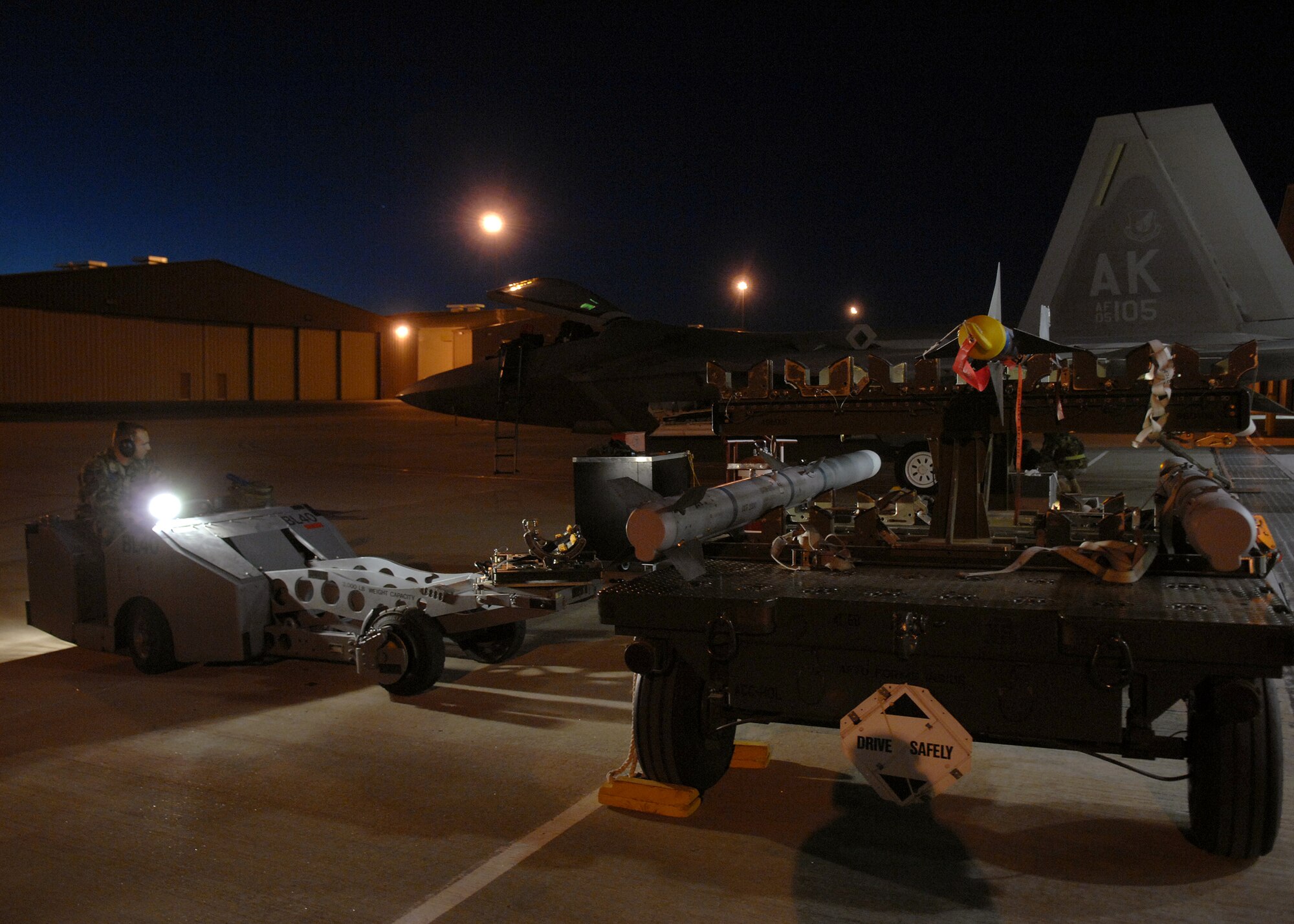 Senior Airman Chad Eichmeier, weapons three man jammer driver, drives a jammer before loading a bomb onto an F-22A Raptor, Jan. 15, at Holloman Air Force Base, N.M. Airmen and pilots gear up for their upcoming exercise Red Flag at Nellis AFB, N.V., starting around the end of January. The Red Flag exercises, conducted in four-to-six cycles a year by the 414th Combat Training Squadron of the 57th Wing, are very realistic aerial war games. The purpose is to train pilots from the U.S., NATO (North Atlantic Treaty Organization) and other allied countries for real combat situations. This includes the use of "enemy" hardware and live ammunition for bombing exercises within the Nevada Test and Training Range.


(U.S. Air Force photo/ Senior Airman Anthony Nelson Jr)

