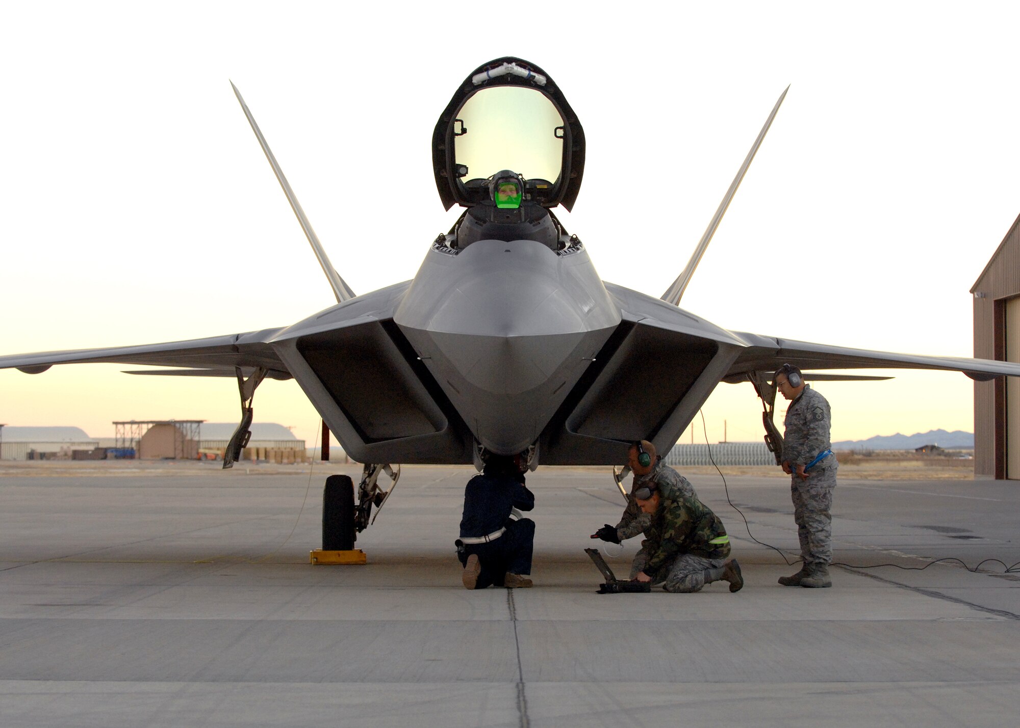 Airmen from the 49th Aircraft Maintenance Squadron work on an F-22A Raptor, Jan. 15, at Holloman Air Force Base, N.M. Airmen and pilots gear up for their training exercise "Red Flag" at Nellis AFB, Nevada, starting around the end of January. The Red Flag exercises, held periodically at the Nellis Air Force Base since 1975, are very realistic aerial war games. The purpose of Red Flag is to give pilots from the U.S., NATO (North Atlantic Treaty Organization) and other allied countries an opportunity to practice and refine their skills for real combat situations. This includes the use of "enemy" hardware and live ammunition for bombing exercises within the Nellis complex

(U.S. Air Force photo/ Senior Airman Anthony Nelson Jr)
