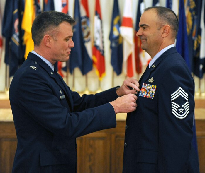 DYESS AIR FORCE BASE, Texas -- Chief Master Sergeant Thomas Buchanan (right), 7th Mission Support Group, received the Bronze Star Medal from Colonel Robert Gass, 7th Bomb Wing commander, here, Jan. 16.  Chief Buchanan and Staff Sergeant Ryan Oliver received the prestigious medal for distinguishing themselves by exceptionally meritorious conduct in support of Operation Iraqi Freedom. (U.S. Air Force photo by Staff Sergeant Connor Estes)   