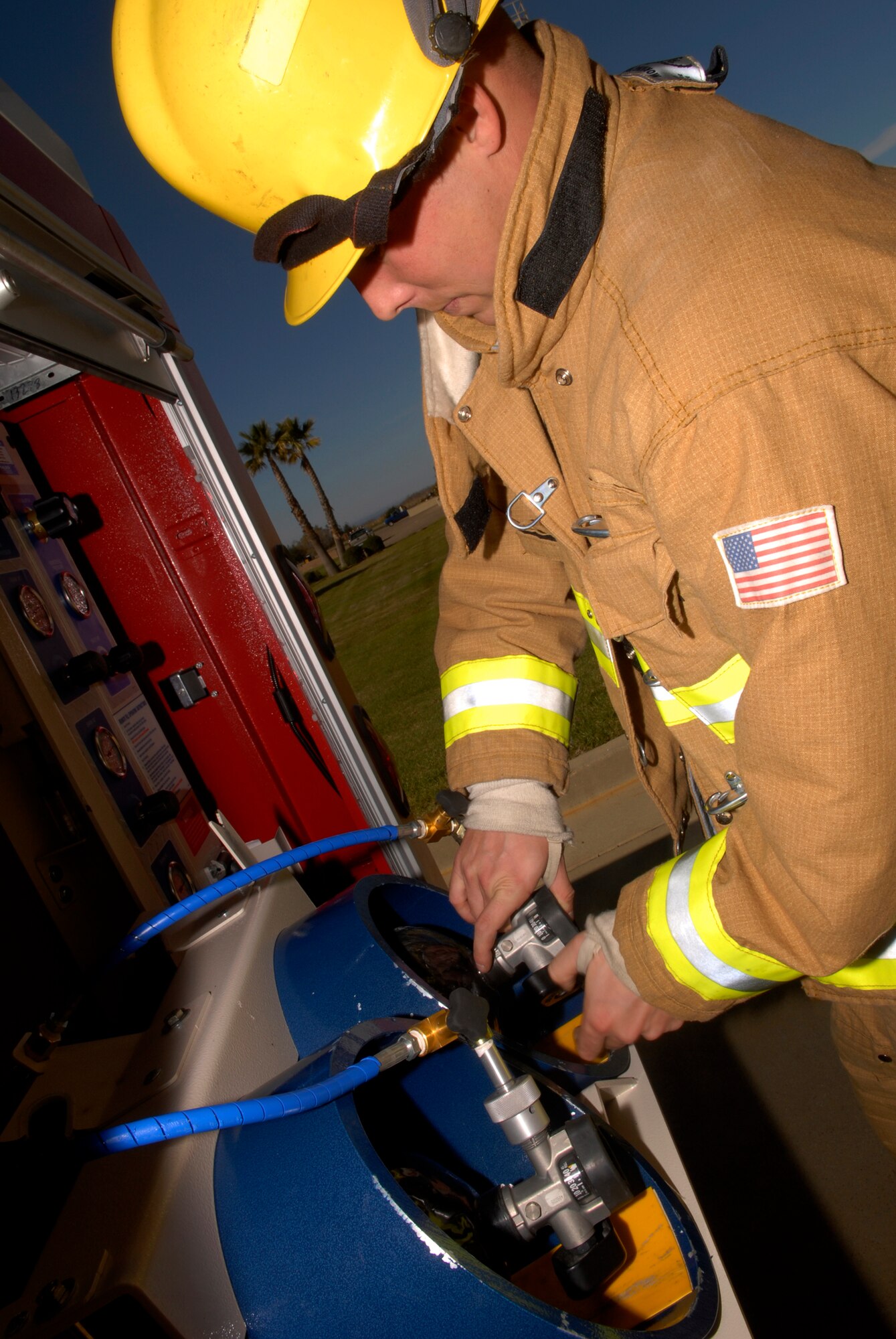 VANDENBERG AIR FORCE BASE, Calif. -- Senior Airman John Templeton, a firefighter with the 30th Civil Engineer Squadron, fills self-contained breathing apparatus tanks using a Mobile Self-Contained Breathing Air Unit on Jan. 20.  The firefighters from the 30th CES purchased this devise through the Productivity Enhancing Capital Investment program and it saved the unit both money and manpower hours. (U.S. Air Force photo/Senior Airman Christian Thomas)
