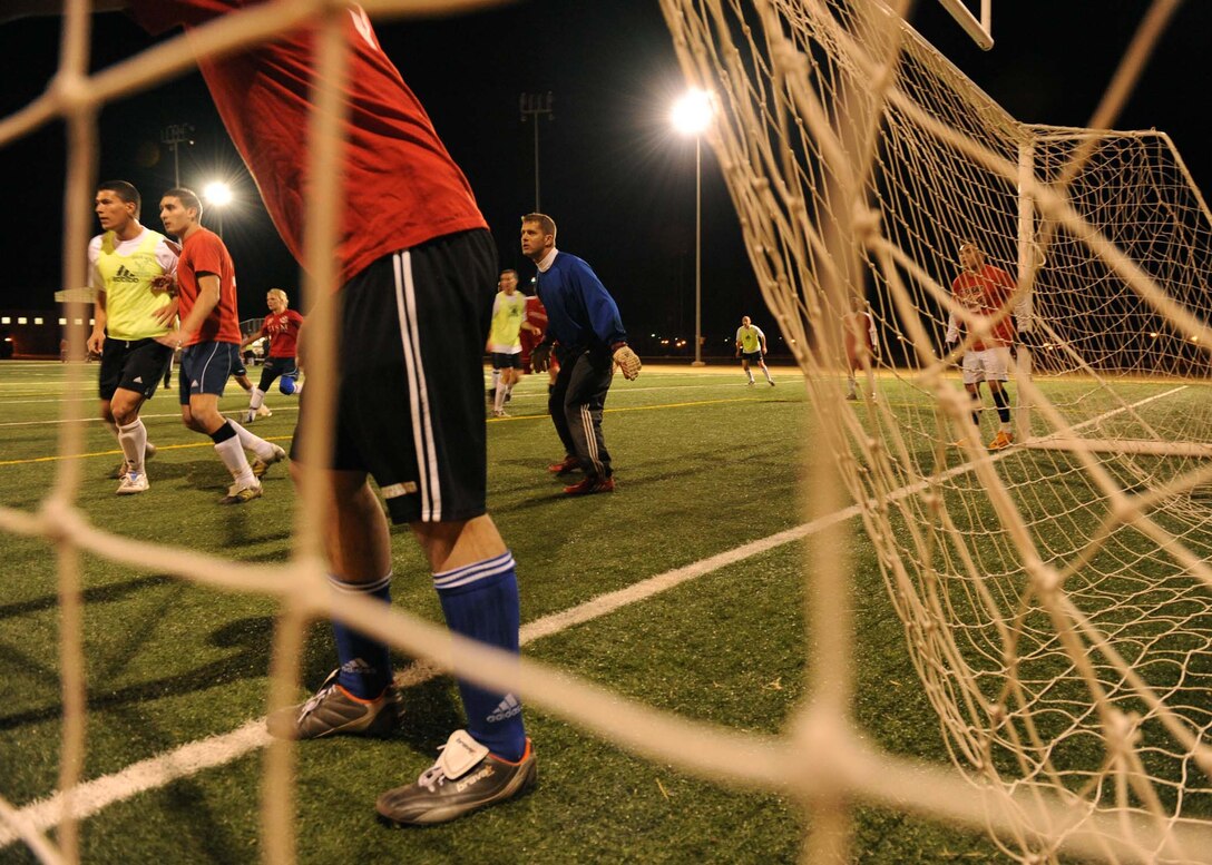 DYESS AIR FORCE BASE, Texas -- Technical Sgt. Timothy Sevigny (goal keeper), 7th Force Support Squadron and First Term Airmen Center NCO in charge, and Senior Airman Nelson Hernandez (yellow jersey), a 317th Aircraft Maintenance Squadron C-130 communications navigation technician, anticipate the incoming corner kick during a scrimmage match between the Dyess varsity team and the Air Force tryout team here, Jan. 14. Sergeant Sevigny and Airman Hernandez have been selected to represent Dyess during the 2009 Air Force Trial/Training Camp from Jan. 10 to Jan. 30.(U.S. Air Force photo by Airman 1st Class Stephen Reyes)