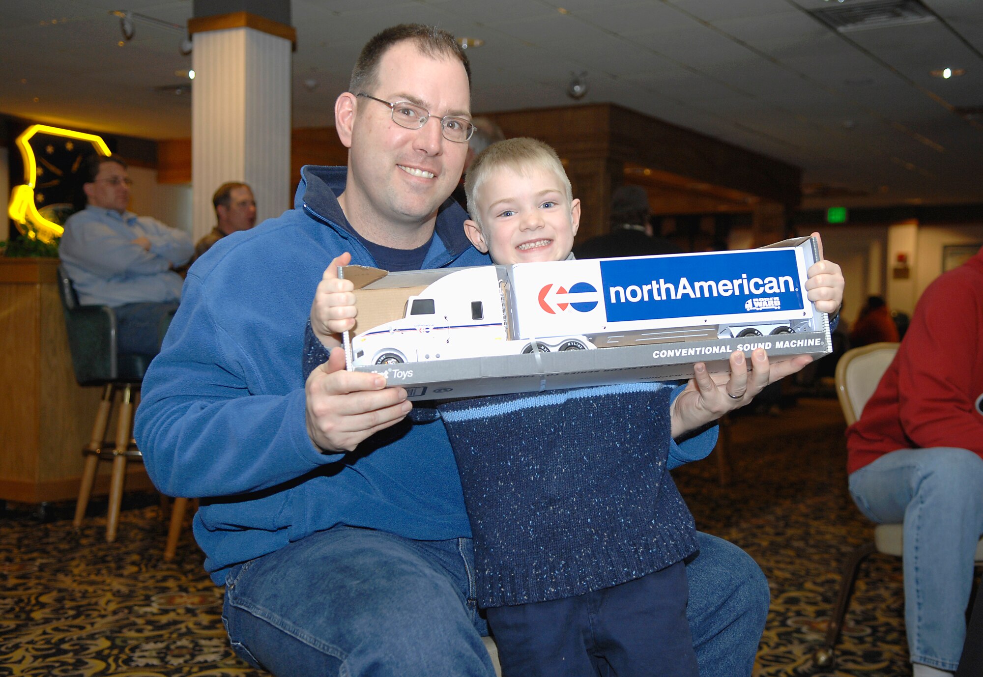 MINOT AIR FORCE BASE, N.D. -- Lt. Col. Greg Sava, 91st Maintenance Group chief of quality assurance, and son, Zach, show off the prize they won at the 44th Annual Sportsmen Feed held at the Jimmy Doolittle Center here Jan. 18. The feed is an annual event designed to build fellowship between the base and local community. (U.S. Air Force photo by Senior Airman Wesley Wright)