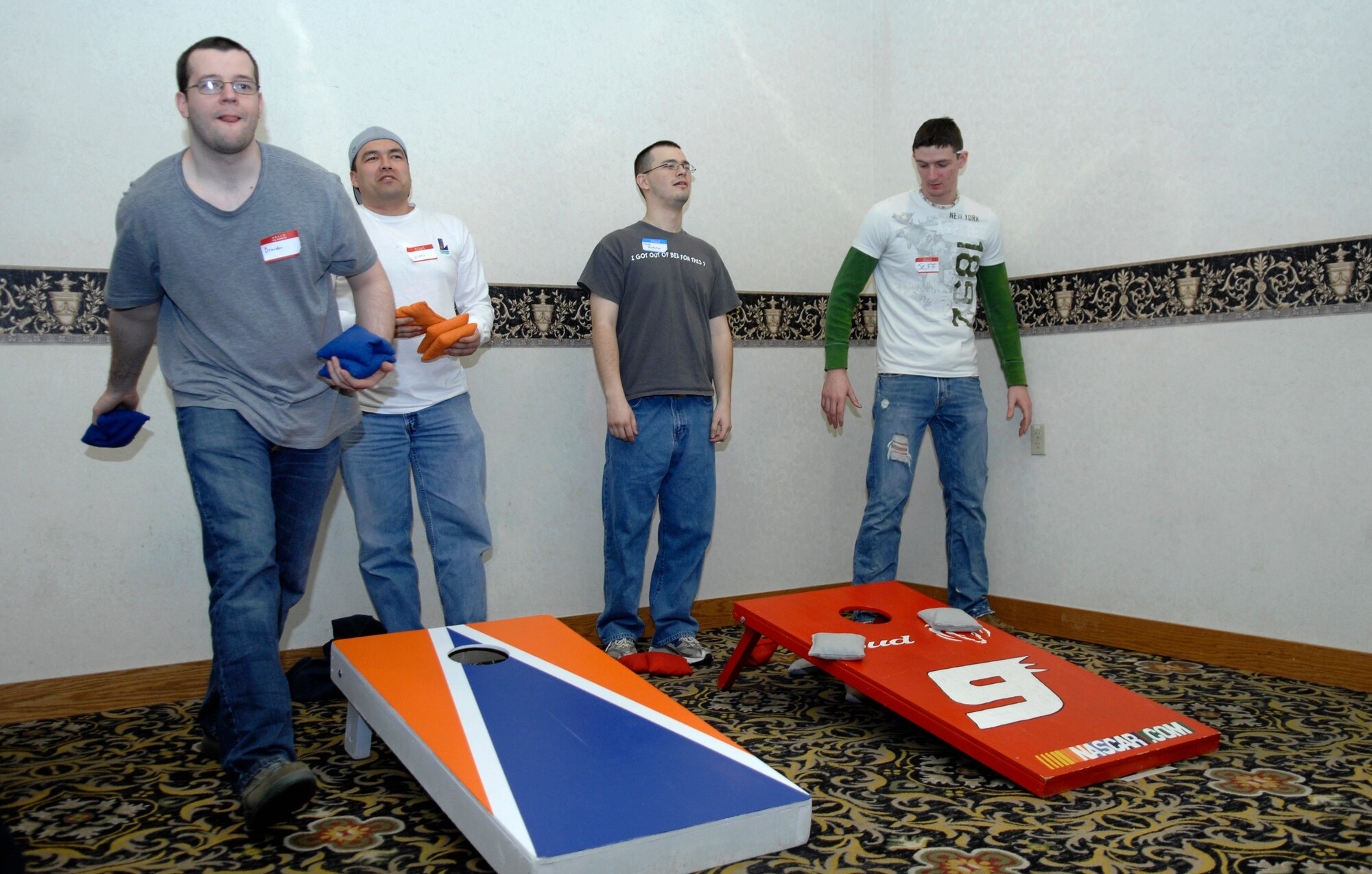 MINOT AIR FORCE BASE, N.D. -- Team Minot Airmen participate in a game called “corn hole” at the 44th Annual Sportsmen Feed held at the Jimmy Doolittle Center here Jan. 18. The feed is an annual event designed to build fellowship between the base and local community. (U.S. Air Force photo by Senior Airman Wesley Wright)