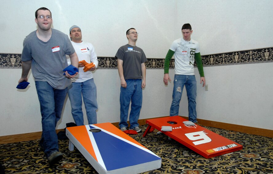 MINOT AIR FORCE BASE, N.D. -- Team Minot Airmen participate in a game called “corn hole” at the 44th Annual Sportsmen Feed held at the Jimmy Doolittle Center here Jan. 18. The feed is an annual event designed to build fellowship between the base and local community. (U.S. Air Force photo by Senior Airman Wesley Wright)