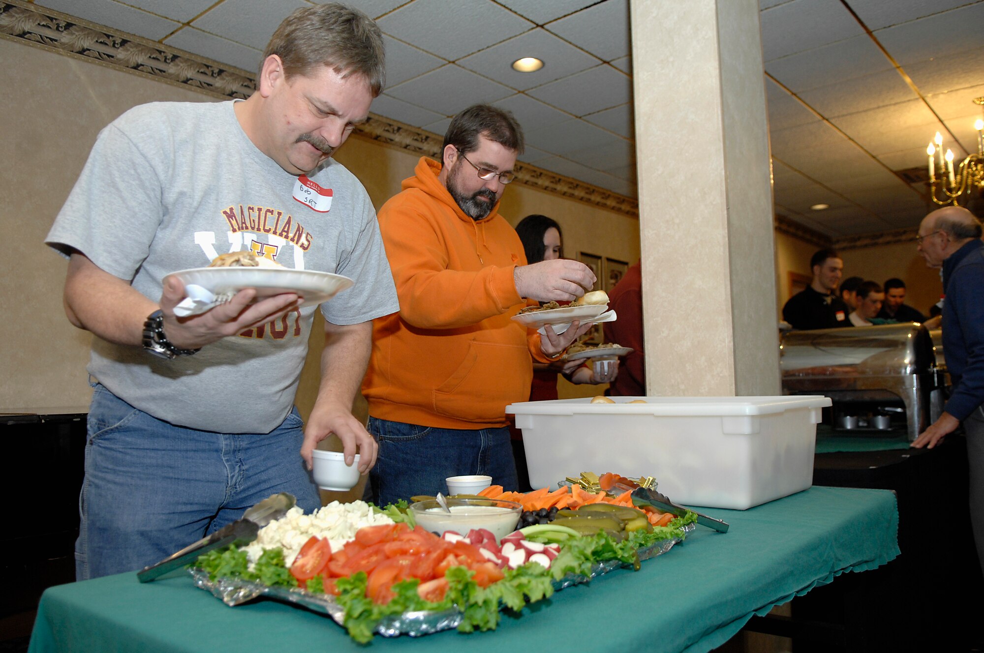 MINOT AIR FORCE BASE, N.D. -- Attendees of the 44th Annual Sportsmen Feed load their plates full of the numerous wild game dishes including such dishes as oven-roasted mallard duck and Missouri River wild turkey at the Jimmy Doolittle Center here Jan. 18. The feed is an annual event designed to build fellowship between the base and local community. (U.S. Air Force photo by Senior Airman Wesley Wright)