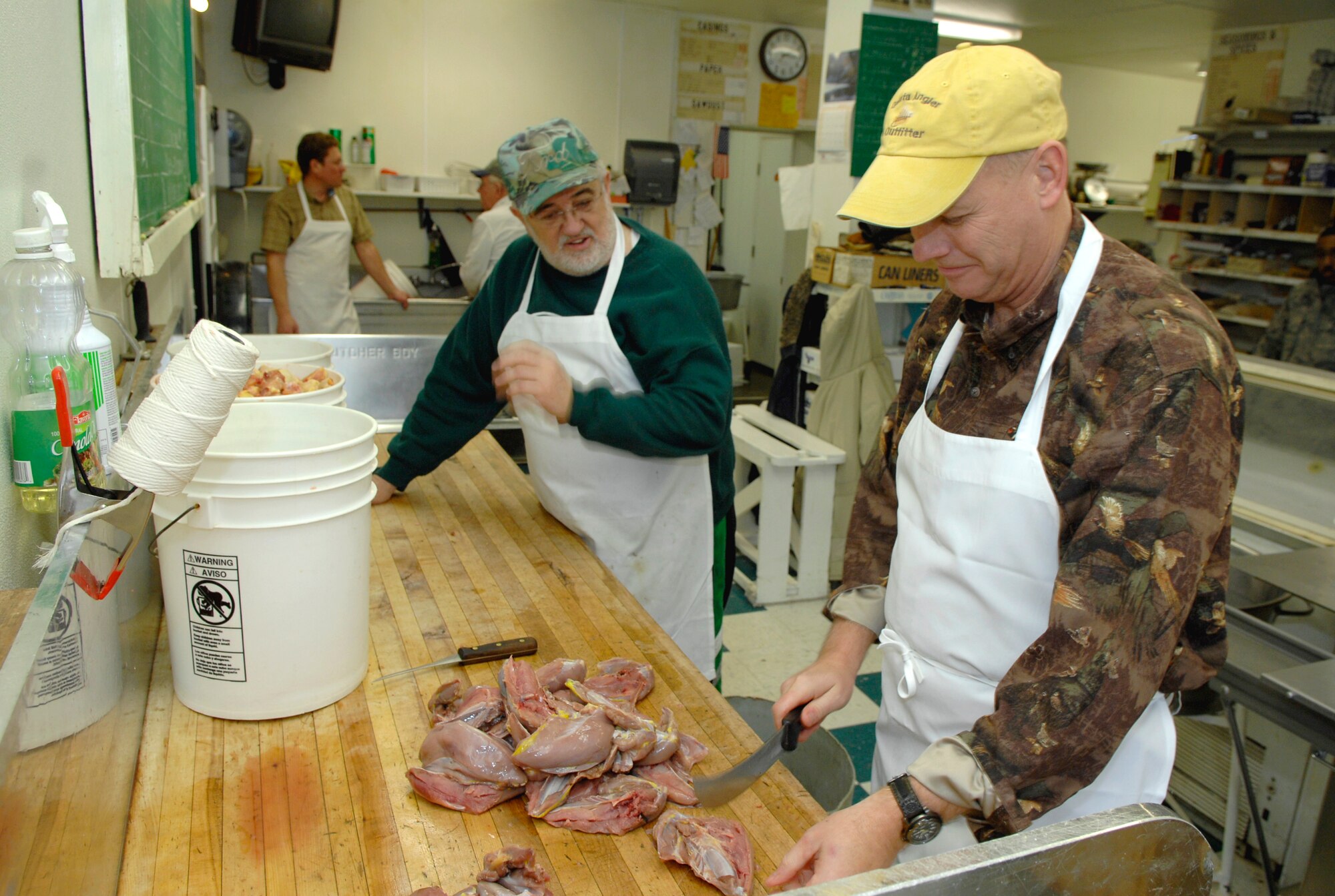 MINOT, N.D. -- Col. Joel Westa (right), 5th Bomb Wing commander, and Joe Quaglia, Sportsmen Feed chairman, prepare pheasant at Blom’s Meat Market here Jan. 16 for the upcoming 44th Annual Sportsmen Feed. The feed, which is an annual event designed to build fellowship between the base and local community, was held at the Jimmy Doolittle Center Jan. 18 at Minot AFB. (U.S. Air Force photo by Airman 1st Class Benjamin Stratton)