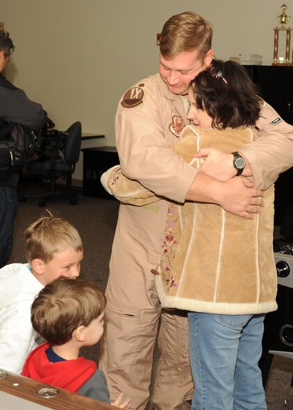 DYESS AIR FORCE BASE, Texas-- Major Steve Graham, from to the 436th Training Squadron, hugs his wife, Annette, and tells his sons, Michael (7) and Sean (3), goodbye before deploying here, Jan. 20. Dyess Air Force Base is in the process of deploying about 300 Airmen. (U.S. Air Force photo by Senior Airman Felicia Juenke)