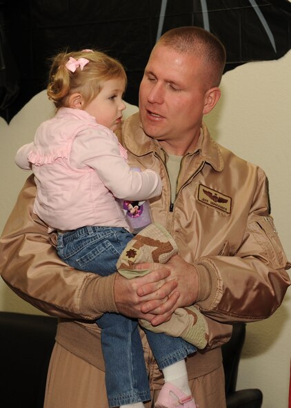 DYESS AIR FORCE BASE, Texas -- Major Jeff Donhauser, from the 9th Bomb Squadron, hugs his daughter, Bayleigh, before deploying here, Jan. 20. Over the next few weeks Dyess Air Force Base will deploy about 300 Airmen. (U.S. Air Force photo by Senior Airman Felicia Juenke)