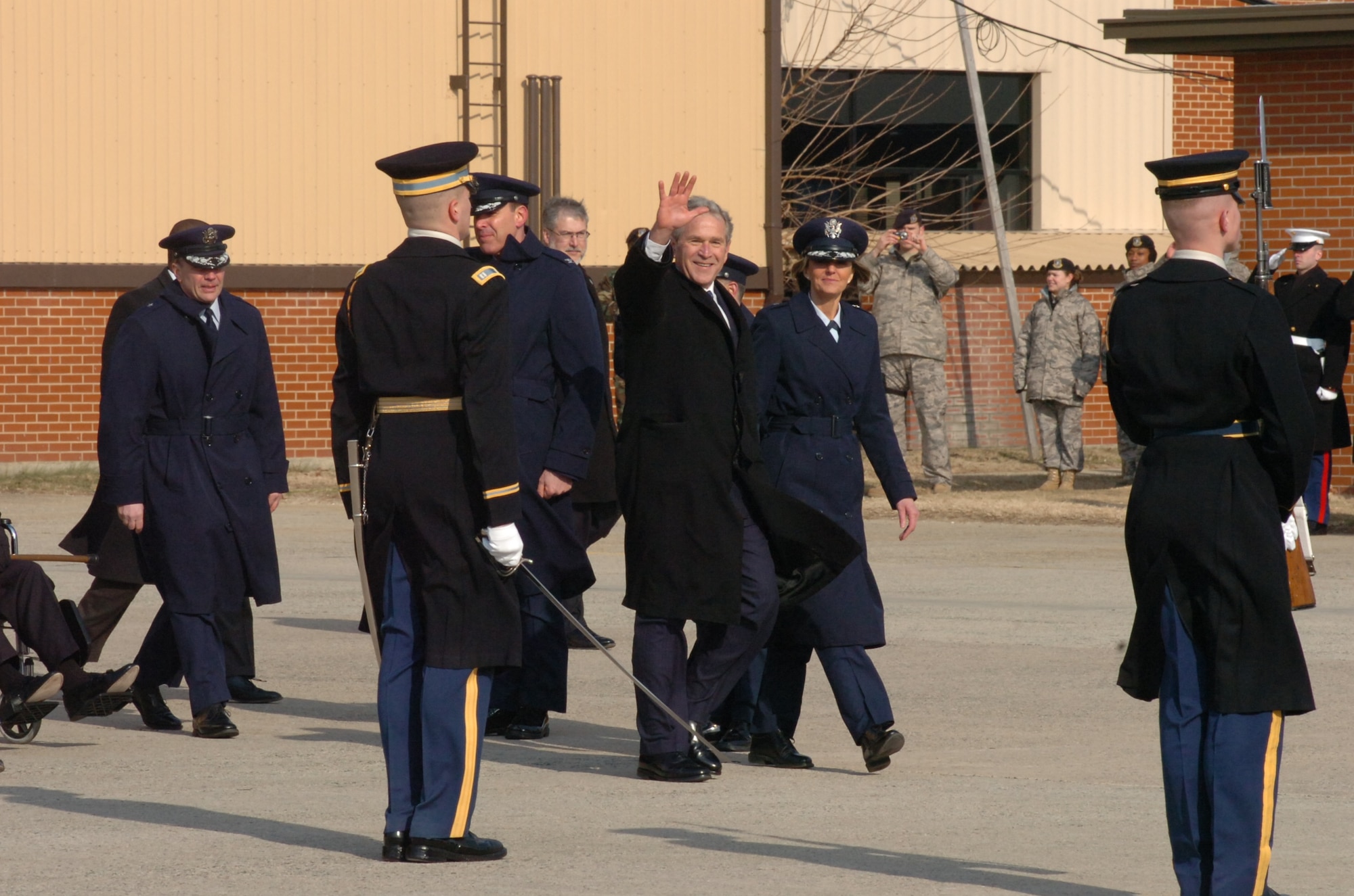 Former President George W. Bush walks along a joint service cordon with Brig. Gen. Margaret H. Woodward, 89th Airlift Wing commander, during his final goodbyes at Andrews AFB on Jan. 20. (U.S. Air Force by Bobby Jones)