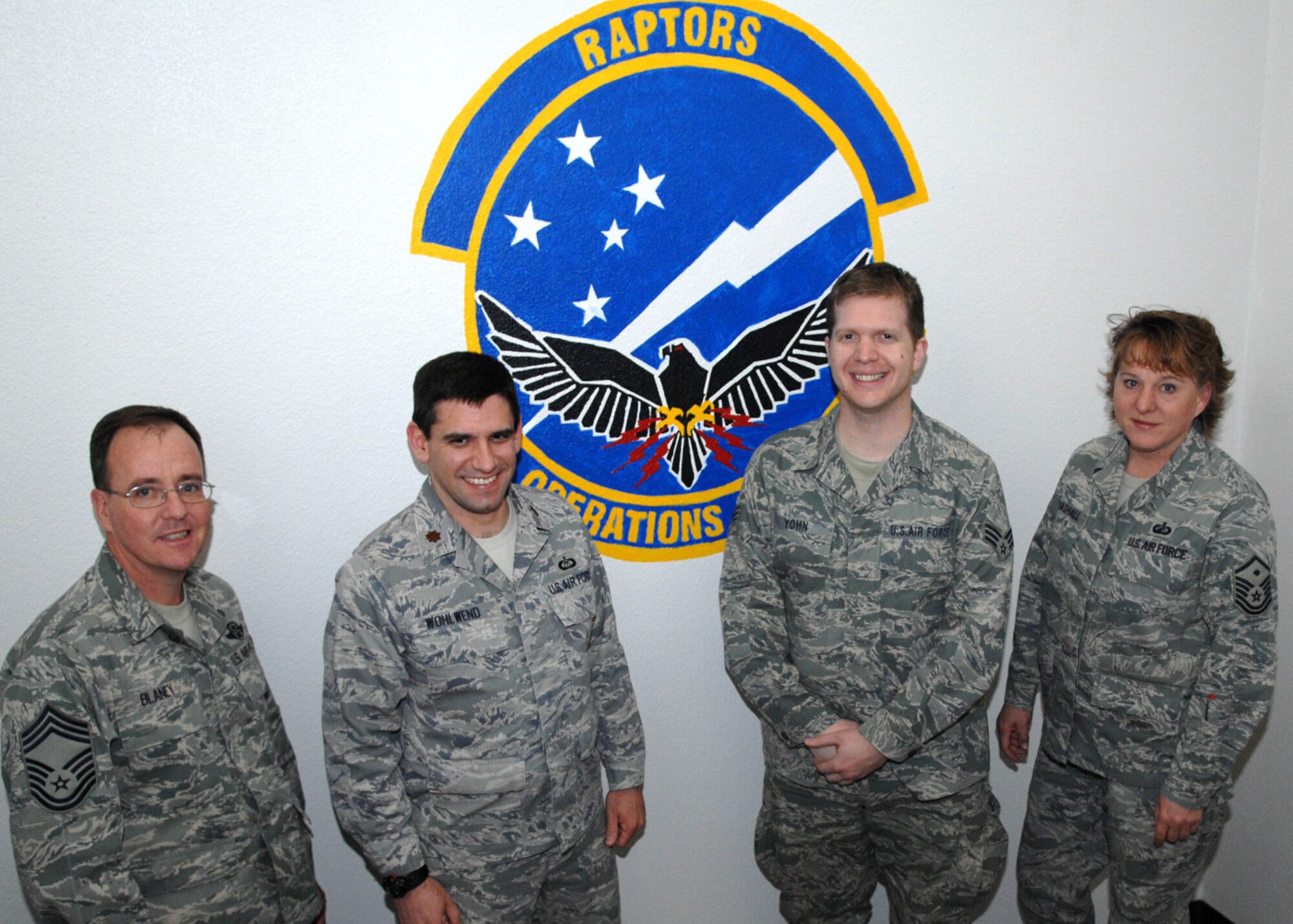 Senior Airman Carth Yohn, 49th Operations Support Squadron, poses for a group photo with other members of the 49 OSS upon his return to Holloman Air Force Base, N.M., Jan. 16. Airman Yohn worked as a combat weather specialist during his 180 day deployment to Iraq. (U.S. Air Force photo/Airman 1st Class Veronica Salgado)