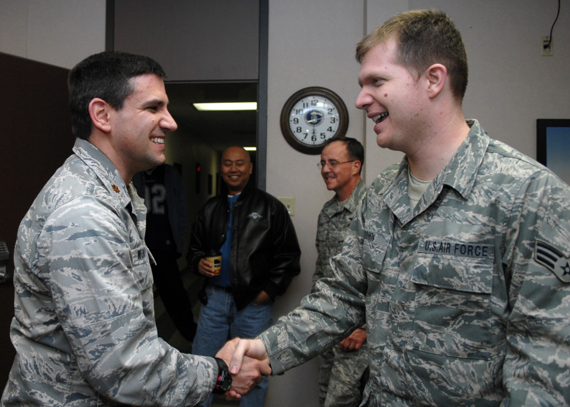 Maj. Christian Wohlwend, 49th Operations Support Squadron weather flight commander, greets Senior Airman Carth Yohn, also 49 OSS, upon his return to Holloman Air Force Base, N.M., Jan. 16. Airman Yohn was deployed to Iraq for 180 days. (U.S. Air Force photo/Airman 1st Class Veronica Salgado)