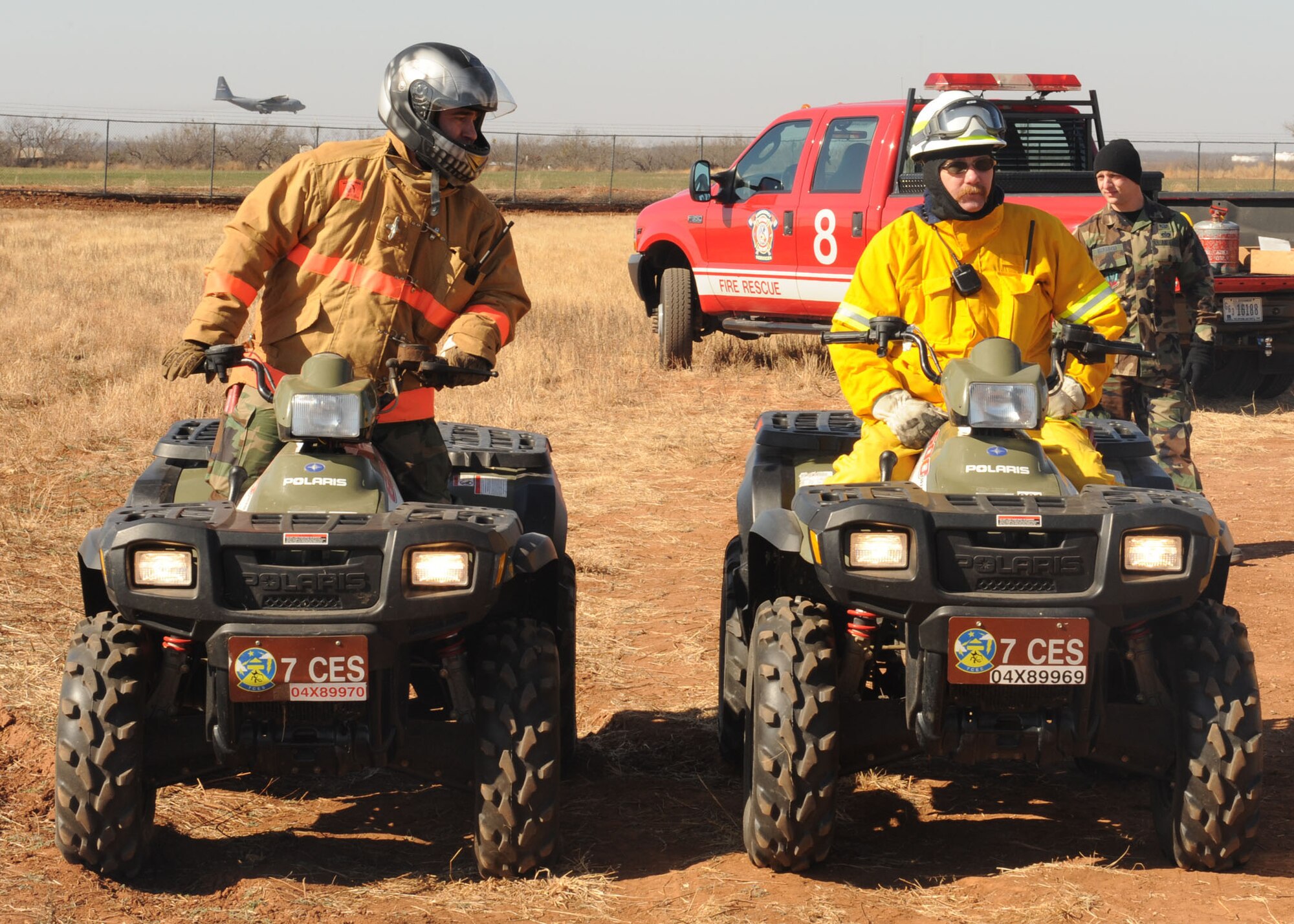 DYESS AIR FORCE BASE, Texas -- Technical Sgt. Glenn Landry and Reed Tate, both firefighters from the 7th Civil Engineering Squadron, utilize All Terrain Vehicle's in order to control the fire during a controlled burn here, Jan. 15. The firefighters stay in constant communication with each other in order to respond quickly in case the fire spreads outside the controlled area.(U.S. Air Force photo by Senior Airman Felicia Juenke)
