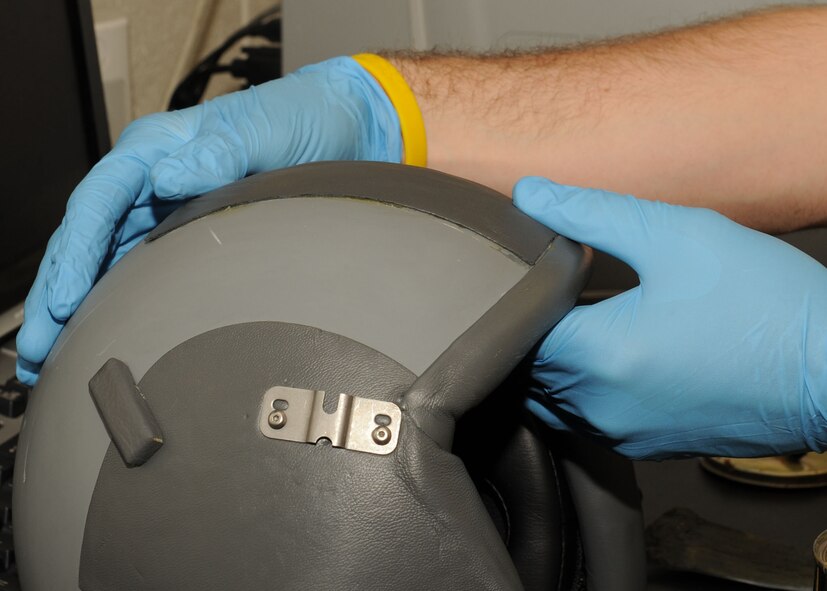 DYESS AIR FORCE BASE, Texas -- Airman 1st Class Christopher Burton, from the 7th Operation Support Squadron, applies a visor buffer to a pilot's helmet here, Jan. 15. A visor buffer is used to reduce the amount of scratches on the visor of the helmet.  (U.S. Air Force photo by Senior Airman Felicia Juenke)