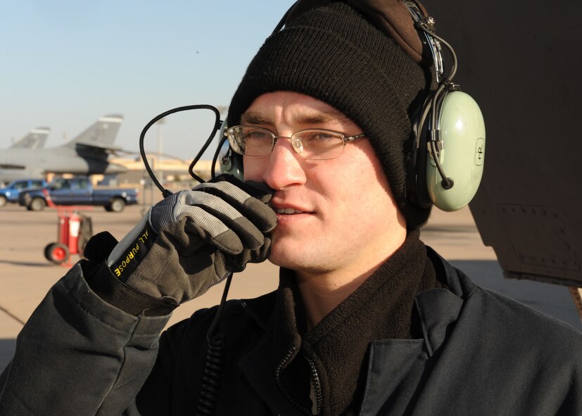 DYESS AIR FORCE BASE, Texas -- Senior Airman Jonathan Yarbarough, from the 7th Aircraft Maintenance Squadron, performs an operation check on his communication headset to ensure all his gear works properly while out on the flight line here, Jan. 15. Ensuring that he can stay in constant communication with the pilots and Command Post is an essential part of aircraft maintenance.(U.S. Air Force photo by Senior Airman Felicia Juenke)