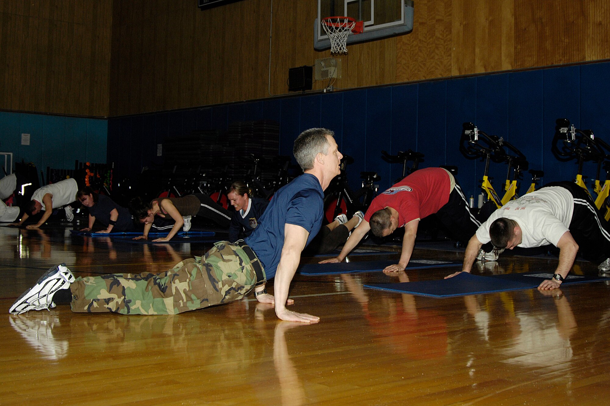 John Smith, Boot Camp instructor, leads a class through strength-training exercises Jan. 14. Boot Camp meets Mondays and Wednesdays at 4 p.m. and is one of the Fitness and Sports Center's free fitness classes. Other classes include spinning, Tae Kwon Do, Pilates, yoga, boxing aerobics and circuit training.  For a class schedule visit www.hanscomservices.com/FitnessClasses120508.pdf.  (U.S. Air Force photo by Linda LaBonte Britt)