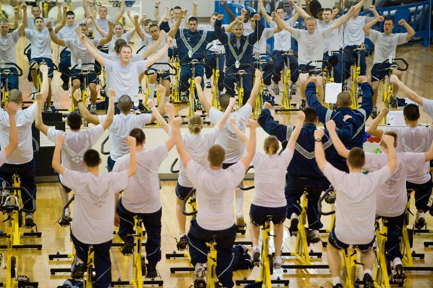 Staff Sgt. Ronald West, 62nd Force Support Squadron, top left, celebrates with a group of first term Airmen upon completing a 35-minute, zero-impact, full body cardiovascular workout spin class Jan. 16 at the McChord fitness center annex. (U.S. Air Force photo/Abner Guzman)