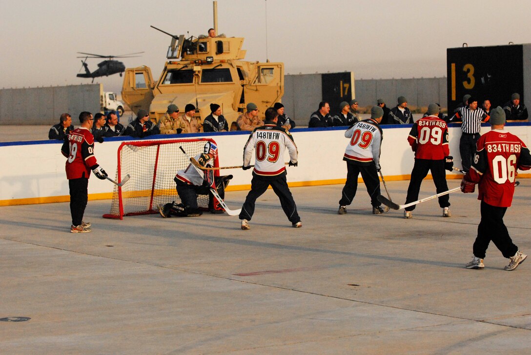Minnesota National Guardsmen compete in the Jan. 17 Minnesota Hockey Day in Iraq game between the Soldiers of the 834 Aviation Support Battalion "Skaters? and the Airmen of the 148 Fighter Wing "Bulldogs.?  Gameplay was punctuated by coalition aircraft who shared the flight line with the hockey rink. The game was held in conjunction with Fox Sports Net North's Minnesota Hockey Day coverage. The 834 ASB and the 148 FW are Minnesota National Guard units currently deployed to Joint Base Balad, Iraq in support of Operation Iraqi Freedom.