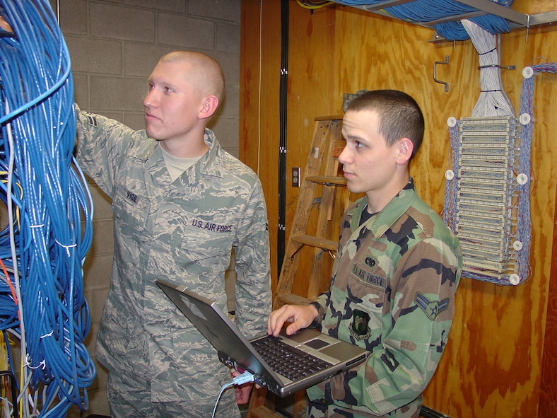 MINOT AIR FORCE BASE, N.D. -- Senior Airman Antonio Vigil and Senior Airman Thomas Mendez,  both 5th Communications Squadron network infrastructure technicians, perform a routine check on a network router here recently. (Courtesy photo)