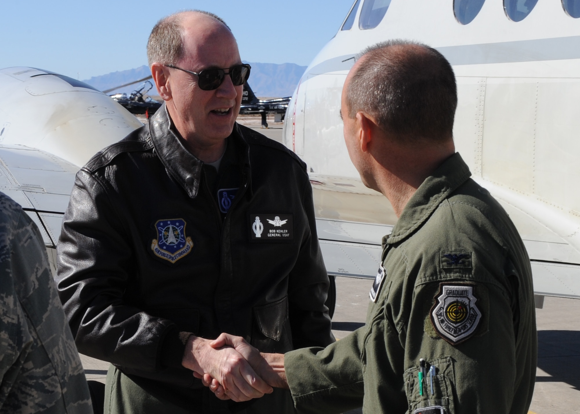 Col. Jeff Harrigian, 49th Fighter Wing commander, greets Gen. C. Robert Kehler, Air Force Space Command commander at Holloman Air Force Base, N.M., Jan. 14. General Kehler visits Holloman to interact with the Airmen from the 4th Space Control Squadron and to speak with the 49th Fighter Wing commander to renew his visibility of Holloman Air Force Base. (U.S. Air Force photo/SrA Michael Means)
