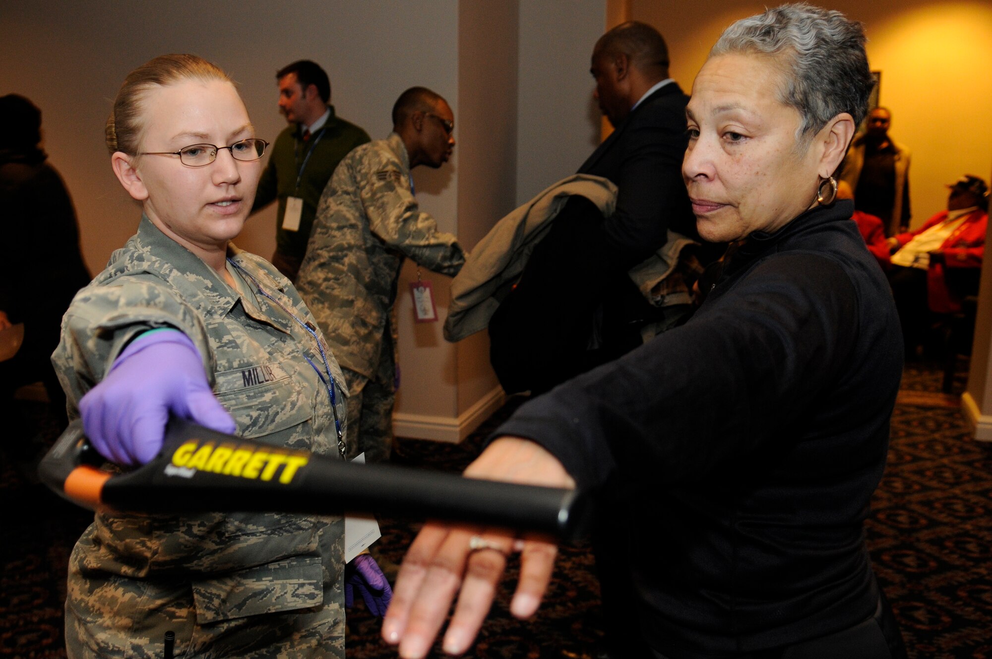 Senior Airman Marcy Miller, 11th Security Forces Squadron, wands a family member of an original Tuskegee Airman Jan. 20 on Bolling. More than 180 Tuskegee Airmen and their families gathered for a breakfast  and security clearing at the Bolling Club, before being bused downtown for the 2009 inaugural events. (U.S. Air Force photo by Staff Sgt. Dan DeCook)