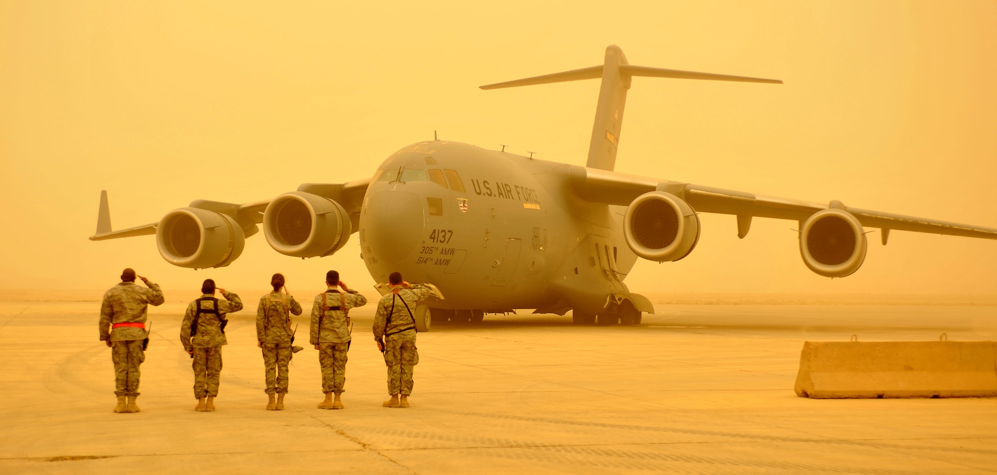 The 447th Air Expeditionary Group command staff salutes the arrival of Chairman of the Joint Chiefs of Staff, Navy Adm. Mike Mullen, on the flightline at Sather Air Base, Iraq. The 447th AEG protocol team is responsible for assisting all distinguished visitors with their travel in to and out of Iraq. (U.S. Air Force photo by Master Sgt. Brian Davidson) 