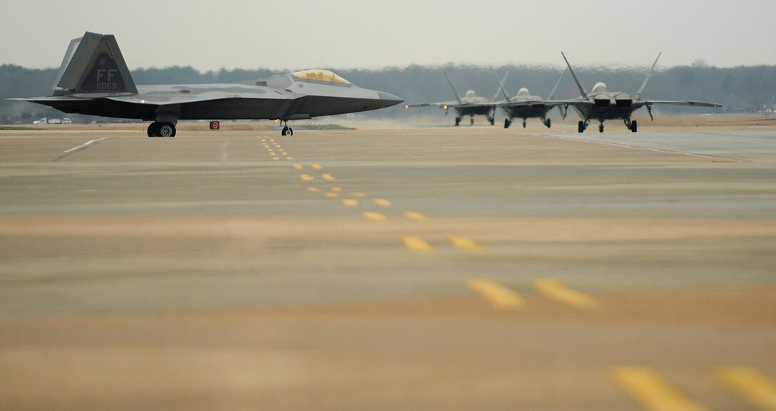 LANGLEY AIR FORCE BASE, Va. --  F-22A Raptors from the 94th Fighter Squadron taxi down the flightline during dissimilar aircraft training with the  Marine Fighter Attack Squadron 312, Beaufort, Jan. 13.  Approximately 53 Marine pilots and crew trained with our F-15C Eagle and F-22A Raptor pilots Jan. 13-15 in preparation for the upcoming Red Flag exercises.  (U.S. Air Force photo/Senior Airman Vernon Young)