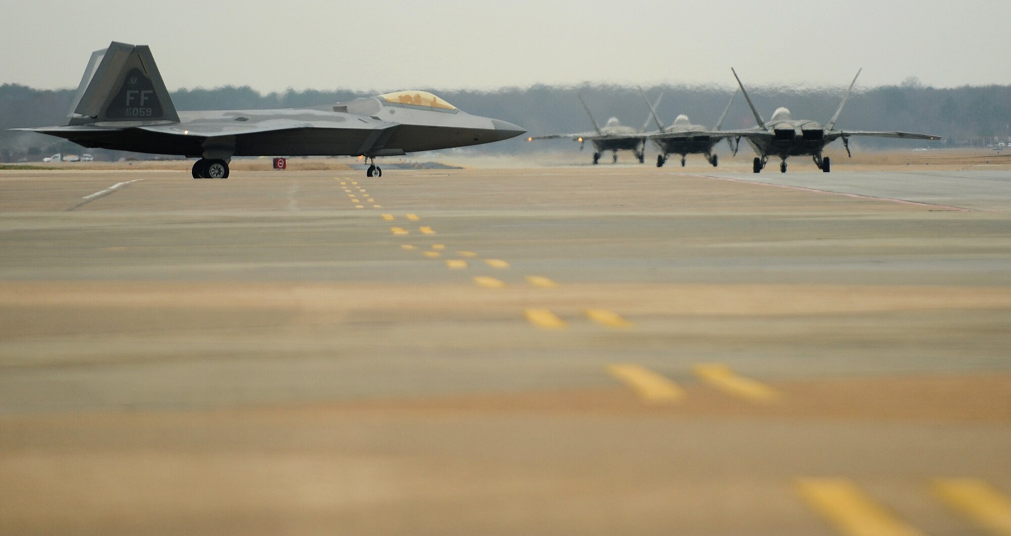 LANGLEY AIR FORCE BASE, Va. --  F-22A Raptors from the 94th Fighter Squadron taxi down the flightline during dissimilar aircraft training with the  Marine Fighter Attack Squadron 312, Beaufort, Jan. 13.  Approximately 53 Marine pilots and crew trained with our F-15C Eagle and F-22A Raptor pilots Jan. 13-15 in preparation for the upcoming Red Flag exercises.  (U.S. Air Force photo/Senior Airman Vernon Young)