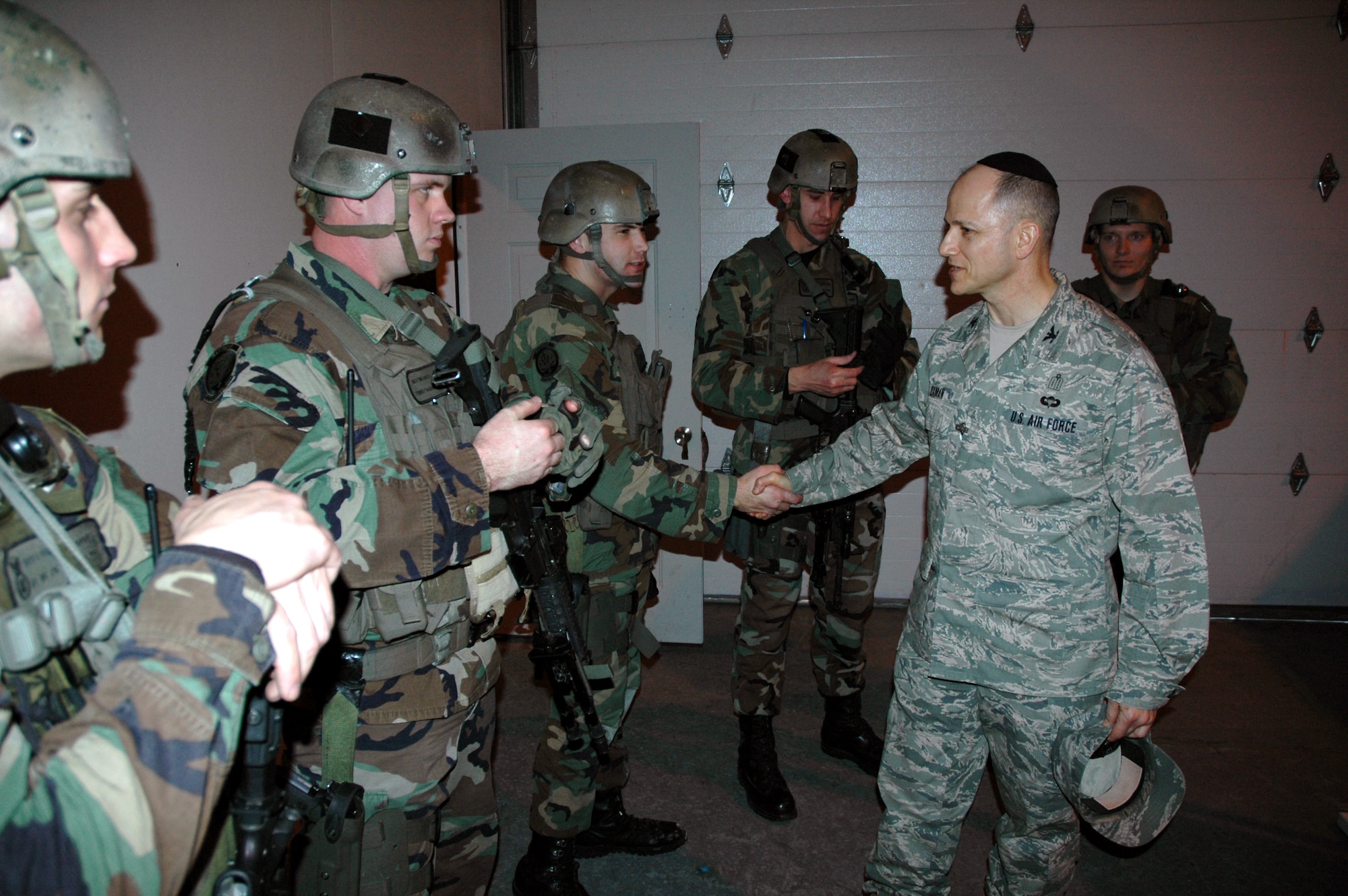 Chaplain (Col.) Brett Oxman, USSTRATCOM chaplain, shakes hands with 341st Security Forces Group tactical response force members following a TRF demonstration at the TRF close-quarters battle center Jan. 12. (U.S. Air Force photo/Senior Airman Dillon White)