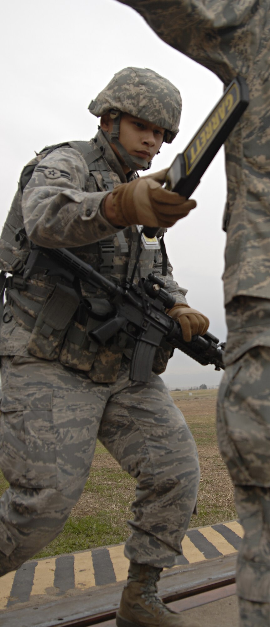 Airman 1st Class Anthony Ornelaz, 39th Security Forces Squadron, searches Staff Sgt. Stephen Ocenosak, American Forces Network Incirlik, before allowing him entry to a controlled area during an exercise, Jan 16. Exercises are held monthly at Incirlik to maintain combat readiness. (U.S. Air Force photo/Senior Airman Benjamin Wilson)