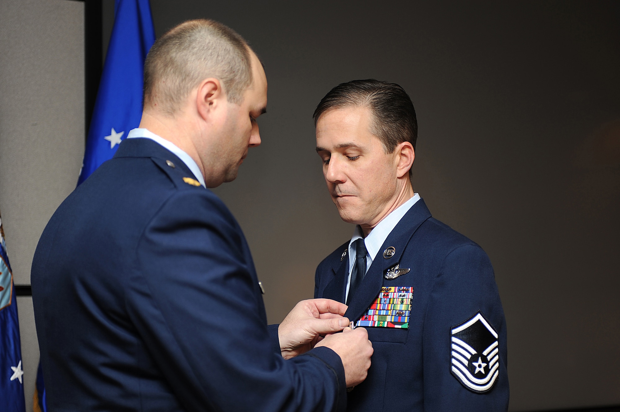 Maj. Robert Barager, Expeditionary Operations School, pins the Meritorious Service Medal on Master Sgt. Peter Richardson during his retirement ceremony in the U.S. Air Force Expeditionary Center on Fort Dix, N.J., Jan. 9, 2009.  Sergeant Richardson was a command tactician for the Combat Aircrew Tactics Studies Course.  He was then selected to fulfill the position of course director for the CATS Course in his last years at the Expeditionary Center. (U.S. Air Force Photo/Staff Sgt. Nathan Bevier)