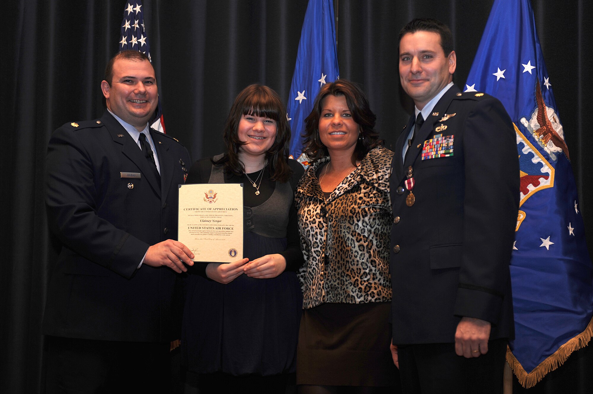 Maj. Craig Juneau, from  Scott Air Force Base, Ill., presents a certificate of appreciation to Elainey, daughter of Theresa and Maj. John M. Yerger during Major Yerger's retirement ceremony in the U.S. Air Force Expeditionary Center on Fort Dix, N.J., Jan. 9, 2009.  Major Yerger was the assistant chief, logistics and resources for the Center's Expeditionary Operations School.  Prior to this position, Major Yerger served for four years in the Air Mobility Battlelab as a project manager and the chief of finance and program support.  Major Yerger's retirement is effective March 1.  (U.S. Air Force Photo/Staff Sgt. Nathan Bevier)