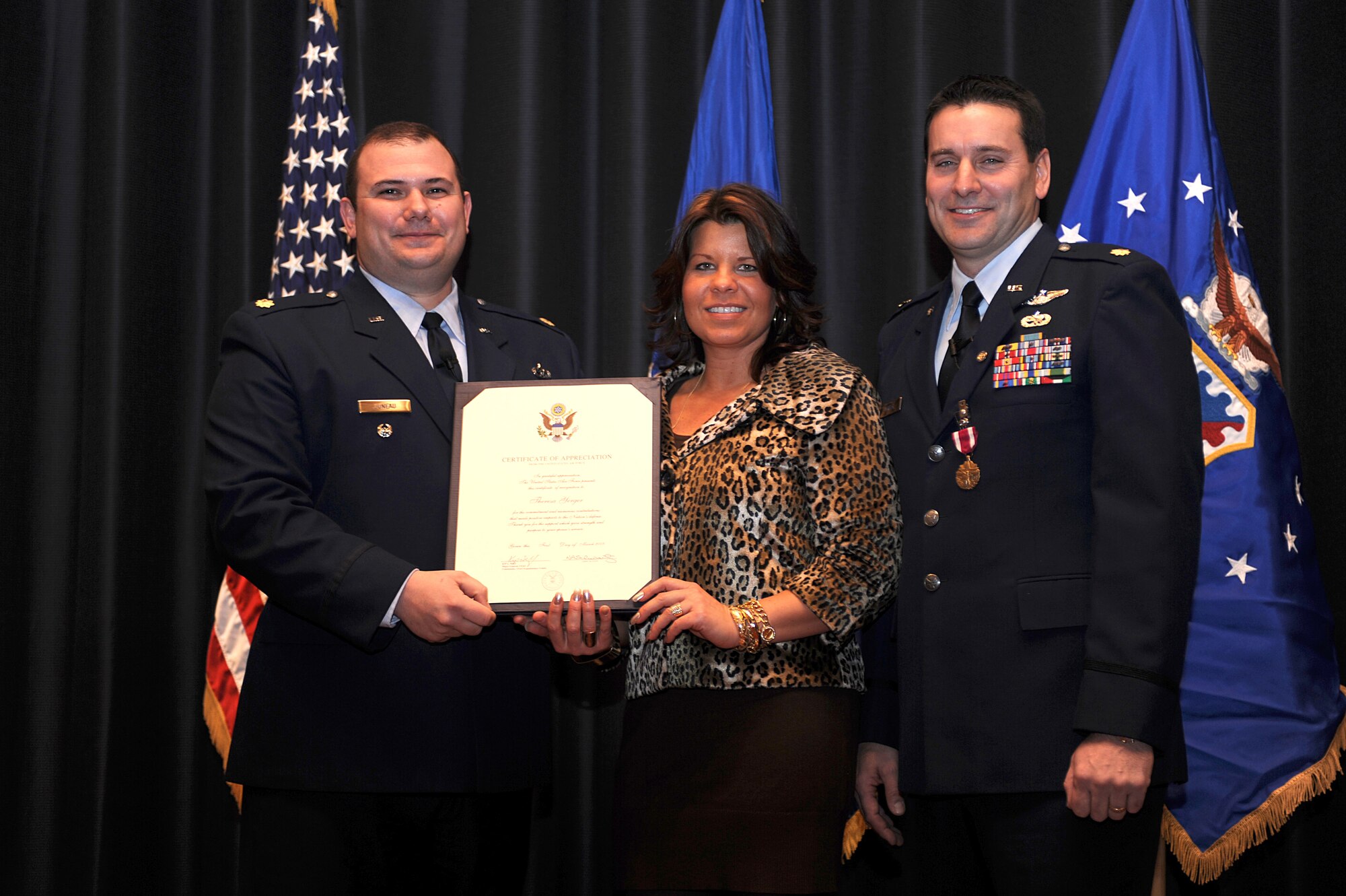 Maj. Craig Juneau, from Scott Air Force Base, Ill., presents a certificate of appreciation to Theresa, wife of Maj. John M. Yerger, during Major Yerger's retirement ceremony in the U.S. Air Force Expeditionary Center on Fort Dix, N.J., Jan. 9, 2009.  Major Yerger was the assistant chief, logistics and resources for the Center's Expeditionary Operations School.  Prior to this position, Major Yerger served for four years in the Air Mobility Battlelab as a project manager and the chief of finance and program support.  Major Yerger's retirement is effective March 1. (U.S. Air Force Photo/Staff Sgt. Nathan Bevier)