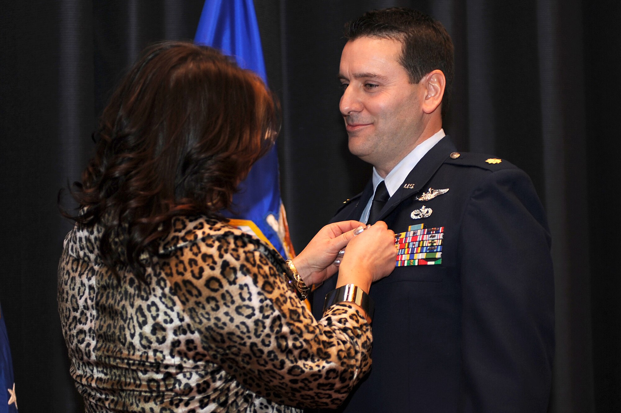 Theresa Yerger pins a retirement pin on her husband, Maj. John M. Yerger, during his retirement ceremony in the U.S. Air Force Expeditionary Center on Fort Dix, N.J., Jan. 9, 2009.  Major Yerger was the assistant chief, logistics and resources for the Center's Expeditionary Operations School.  Prior to this position, Major Yerger served for four years in the Air Mobility Battlelab as a project manager and the chief of finance and program support.  Major Yerger's retirement is effective on March 1. (U.S. Air Force Photo/Staff Sgt. Nathan Bevier)