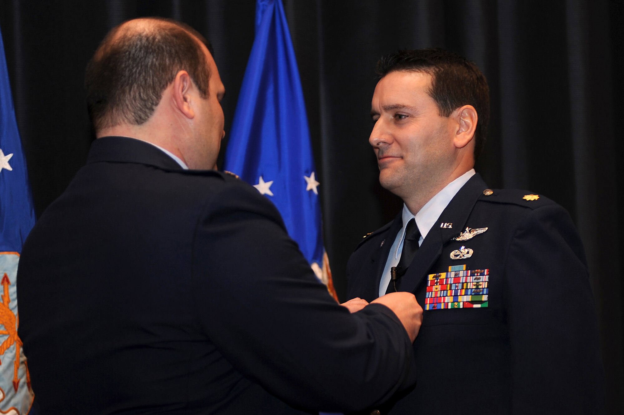 Maj. Craig Juneau from Scott Air Force Base, Ill., pins on a Meritorious Service Medal on Maj. John M. Yerger during his retirement ceremony in the U.S. Air Force Expeditionary Center on Fort Dix, N.J., Jan. 9, 2009.  Major Yerger was the assistant chief, logistics and resources for the Center's Expeditionary Operations School.  Prior to this position, Major Yerger served for four years in the Air Mobility Battlelab as a project manager and the chief of finance and program support.  Major Yerger's retirement is effective on March 1.  (U.S. Air Force Photo/Staff Sgt. Nathan Bevier)