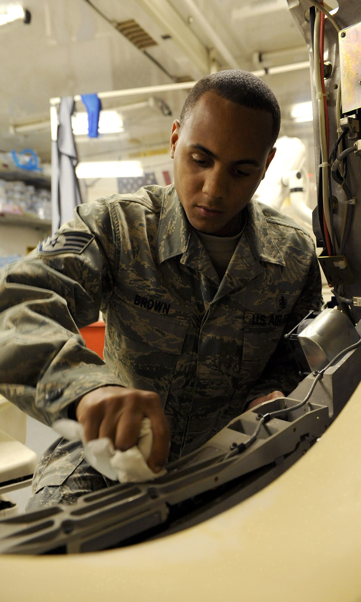 JOINT BASE BALAD, Iraq -- Staff Sgt. Christopher Brown, biomedical equipment technician for the 332nd Expeditionary Medical Support Squadron, cleans a computed tomography machine at the Joint Base Balad Theatre Hospital, Iraq on Jan. 16. Brown is a native of Lynchburg, Va., currently deployed from Scott Air Force Base. The 332nd EMDSS is responsible for maintaining equipment used for patient care. (U.S. photo/ Senior Airman Tiffany Trojca)