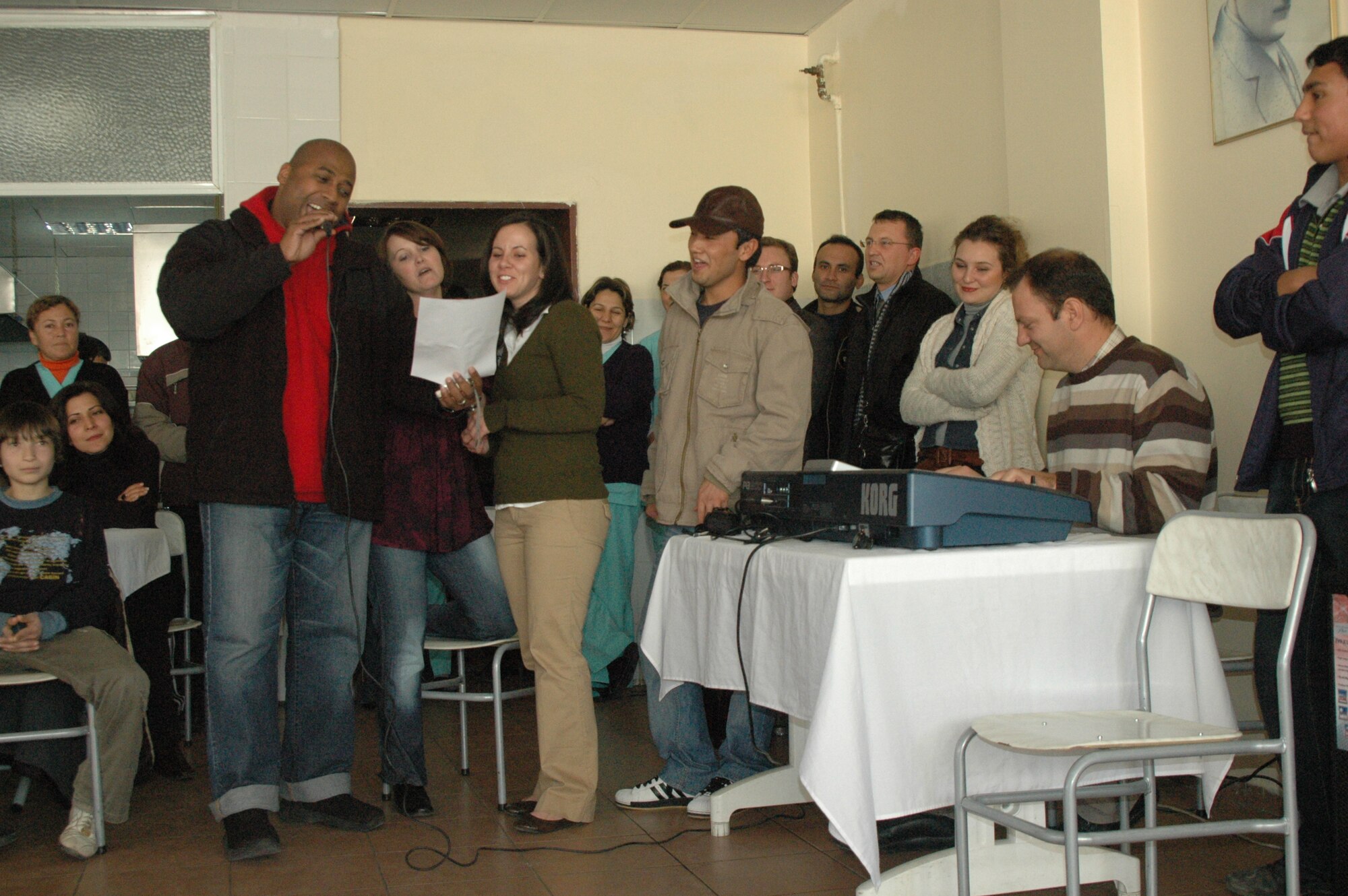 Master Sgt. Lavalle Boswell (left), Master Sgt. Debra Wright and Staff Sgt Amanda Turnbo sing songs for children at the Dokuz Eylül Boys Orphanage Dec. 30.