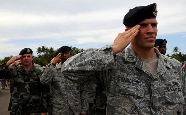 ANDERSEN AIR FORCE BASE, Guam - Capt. Devin Sproston, 736th Security Forces Commando Warrior Officer in Charge, salutes while the National Anthem plays at the Commando Warrior ribbon cutting ceremony here Jan. 20. The 736th SFS will use  the facility to train Airmen in robust combat skills. (U.S. Air Force photo by Airman 1st Class Courtney Witt) 