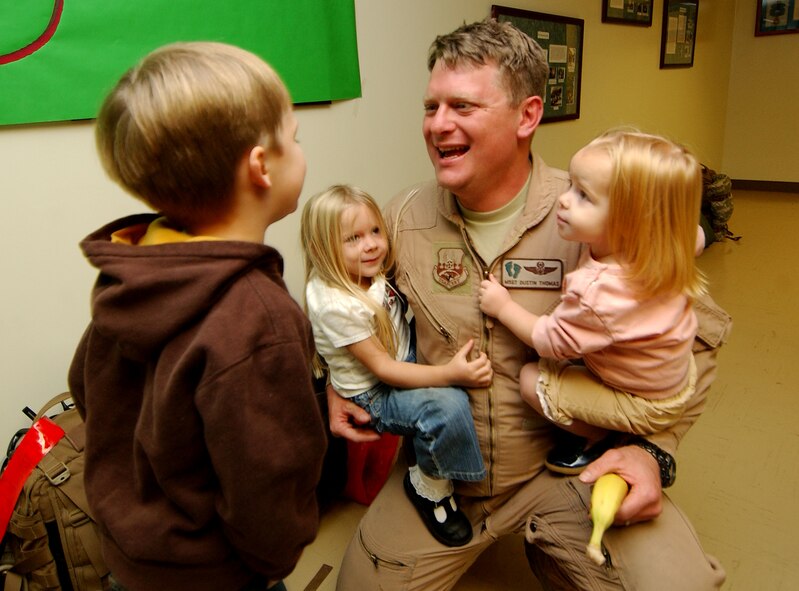 Master Sgt. Dustin Thomas, an HH-60 Pavehawk helicopter gunner, is greeted by his children, Dustin, 6; Lily, 4; and Annie, 2, on Jan. 15. The 33rd Rescue Squadron returned from a three-month deployment to Afghanistan where they provided combat search and rescue support for U.S. and coalition operations. (U.S. Air Force photo/Tech. Sgt. Rey Ramon)